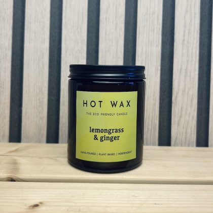 Lemongrass and ginger scented soy candle in amber glass jar