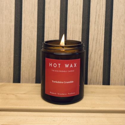 Rhubarb and strawberry scented soy wax candle in amber glass jar